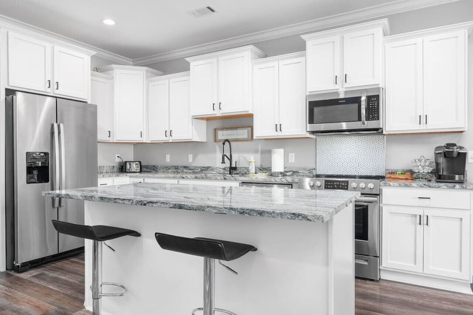 A bright kitchen with a large island—perfect for cooking, dining, or gathering with friends.