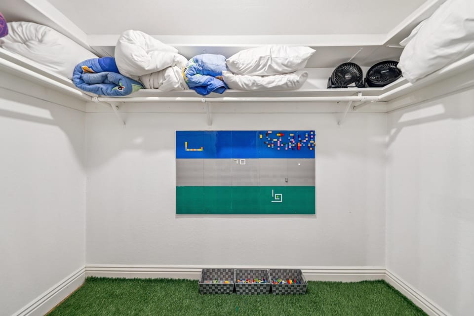 Organized walk-in closet with ample storage and fresh accents