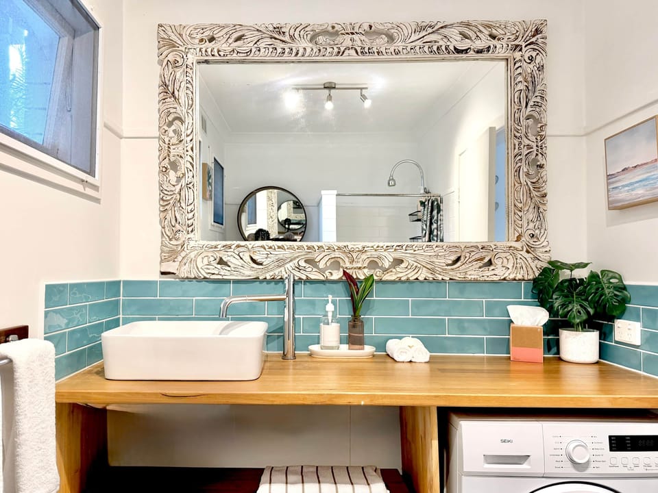 Coastal bathroom with washing machine, ironing facilities and all essentials for a comfortable stay