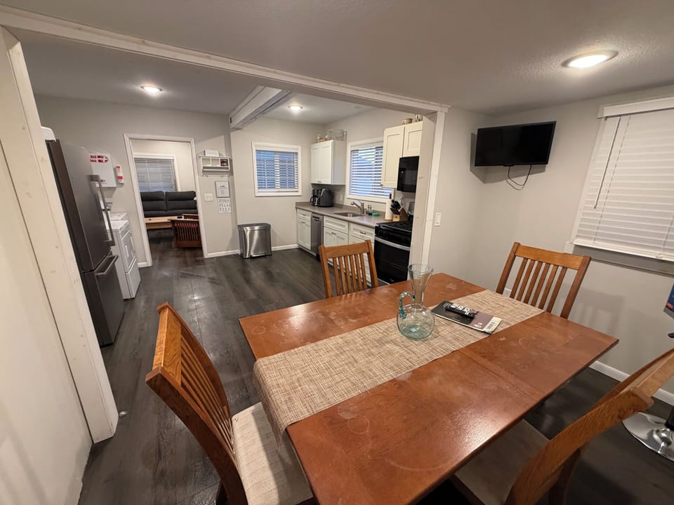 Dedicated dining area with a smart-tv, large kitchen adjacent.