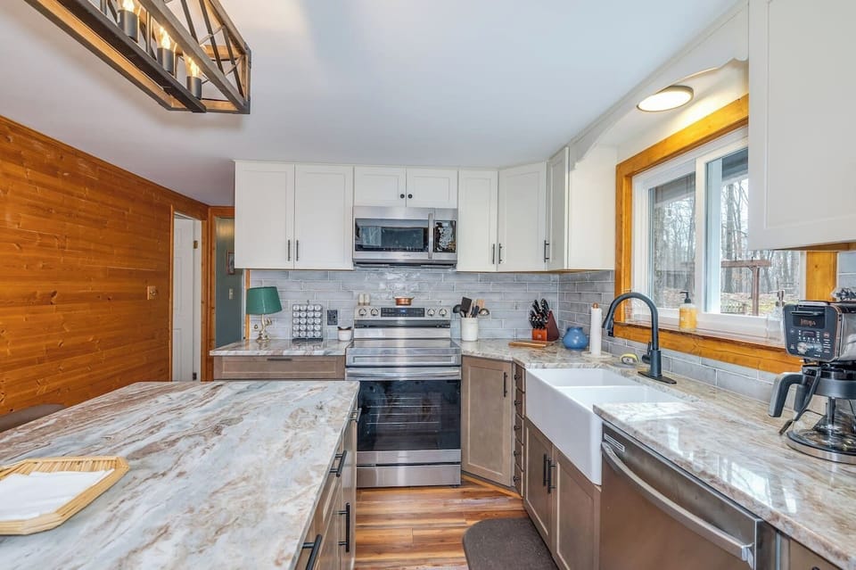 Electric range and stove equipped with Air Fryer function. Coffee station includes Ninja dual-brew coffee maker system (K-pods or grounds, pour over (chemex style), K-pod selection, regular and decaf grounds, electric kettle, tea, and hot cocoa.