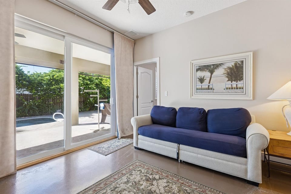 Cozy indoor vibes with a poolside view! Relax, read, or step out for a refreshing dip!