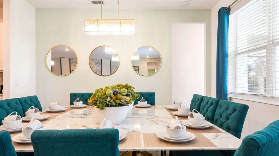 Sophisticated dining space with a marble table, plush seating, and elegant lighting!