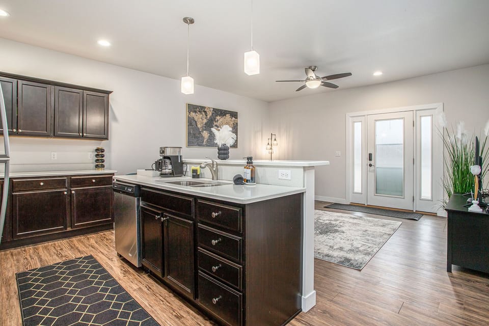 Entertain with ease in our open-concept kitchen, featuring modern appliances, with seamless views of the cozy living area.