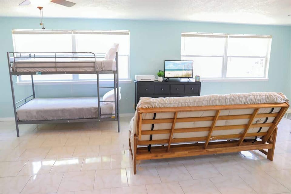Fourth bedroom with queen bed, twin bunk bed, and game room in our License to Chill, Largo vacation rental with heated pool.