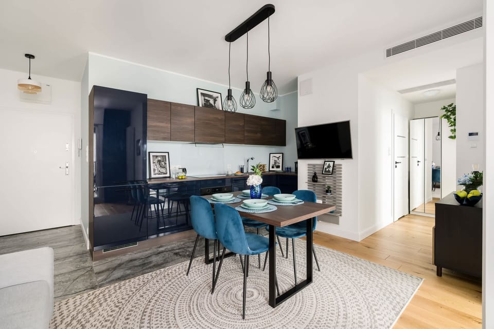 Lliving room and dining area with elegant kitchenette.