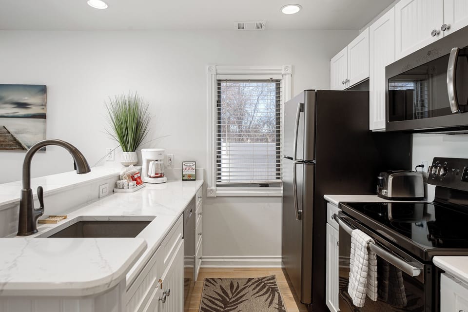 Sleek kitchen w/ stainless steel appliances, ample counter space & modern finishes.