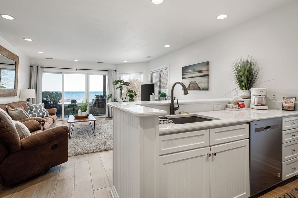 Seamless open-concept layout connecting kitchen, dining & living spaces w/ natural light throughout.