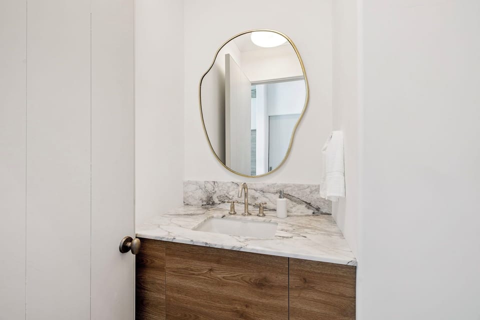 Refresh in your elegantly appointed bathroom featuring marble countertops and modern fixtures for a luxurious start to each day.