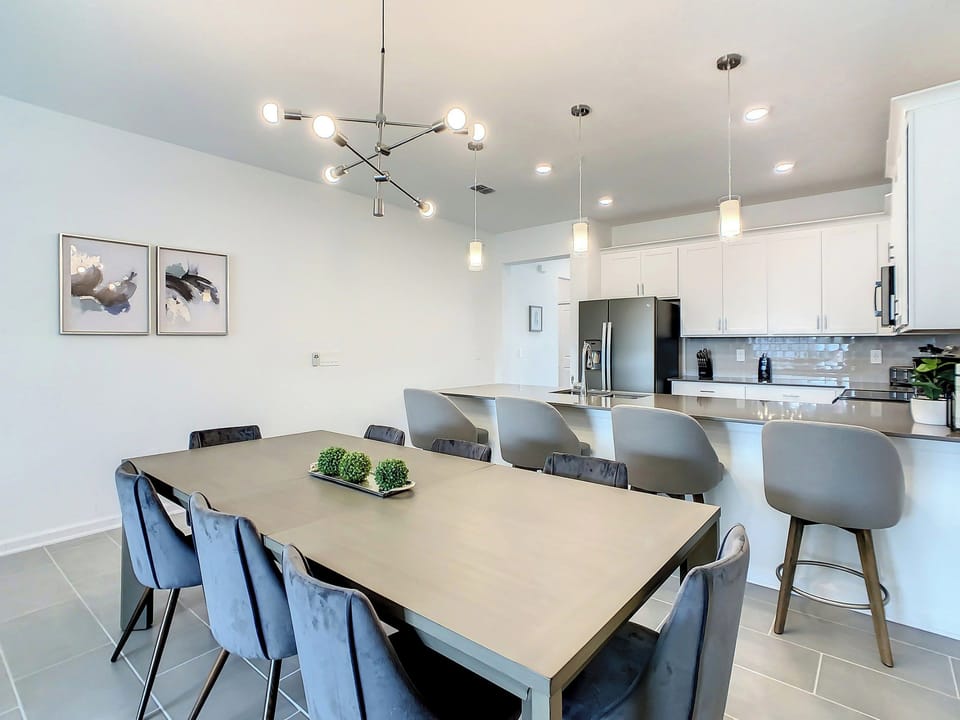 Modern Dining Area with Chic Lighting and Breakfast Bar