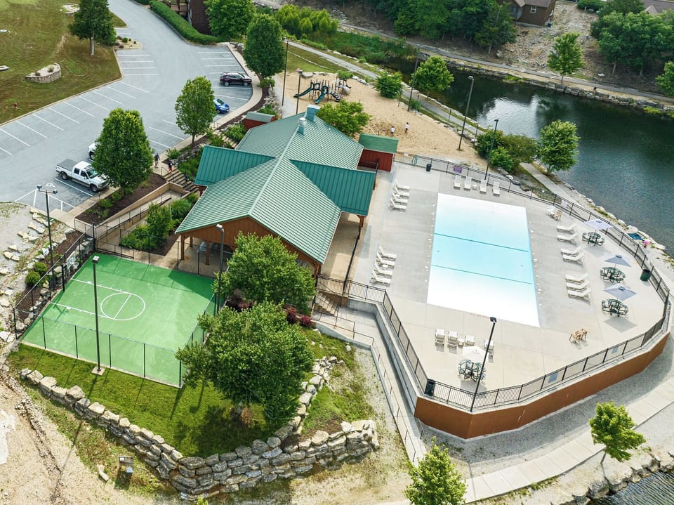 Pool, playground, picnic area, basketball court, and lake