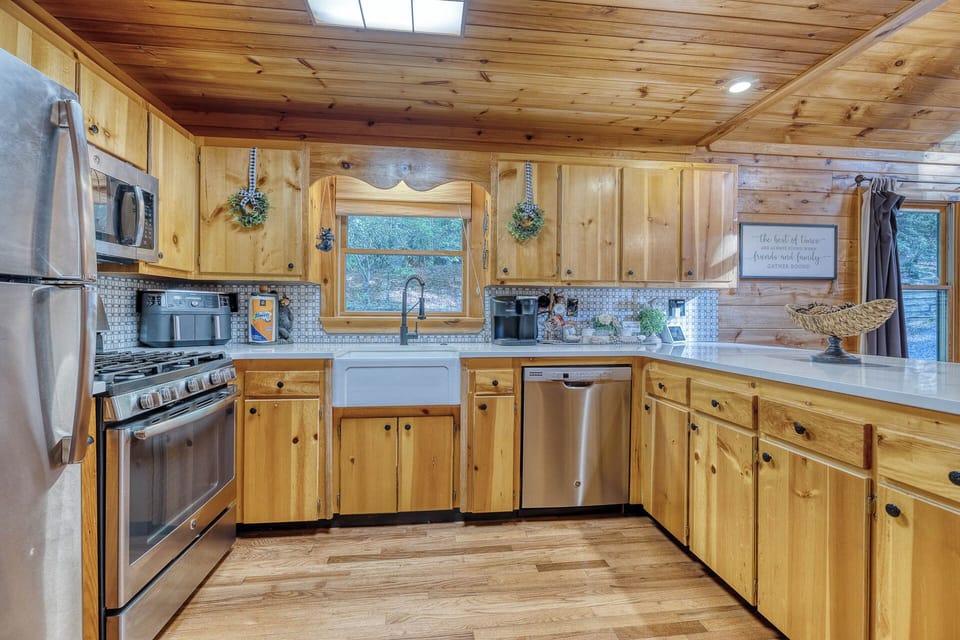 Large, bright kitchen with stainless steel appliances, air fryer, coffee station, crock pot, toaster, blender, rice maker, and fully stocked essentials. Ample counter space perfect for creating a family feast.