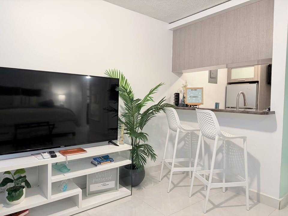 Bright, modern studio with big TV, breakfast bar and sleek kitchenette