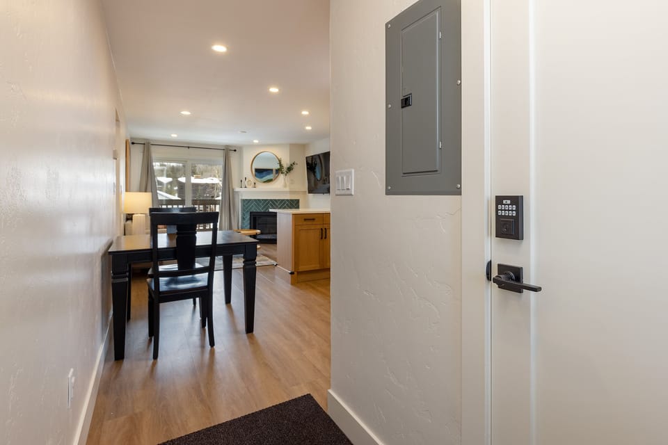 Step into your bright, modern home featuring an open dining area with stylish furnishings and a cozy fireplace perfect for memorable meals.
