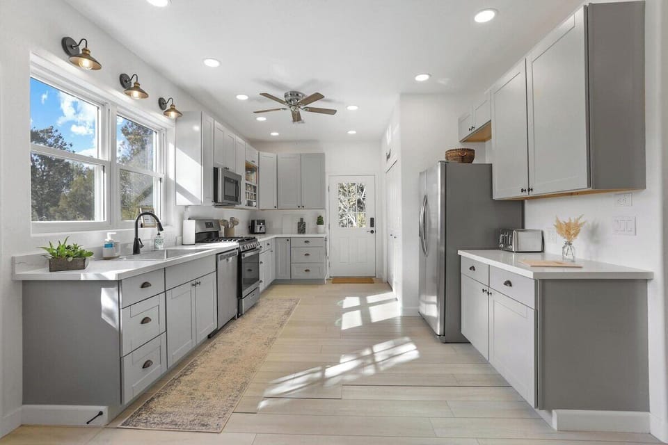 Spacious kitchen allows you to cook every meal during your stay. You will find everything you may need including an air fryer, toaster, blender, and crockpot. Cooking oil and some spices are also provided. 