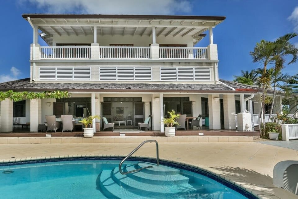 Villa and pool with lots of outdoor space.