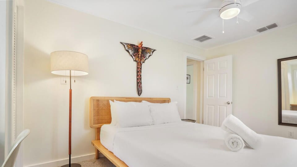 Queen bedroom with luxury hotel quality linens, desk, and closet