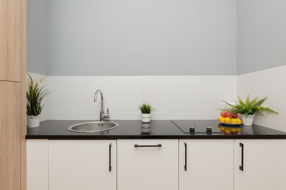 The sleek design of the kitchenette blending seamlessly with the living area.