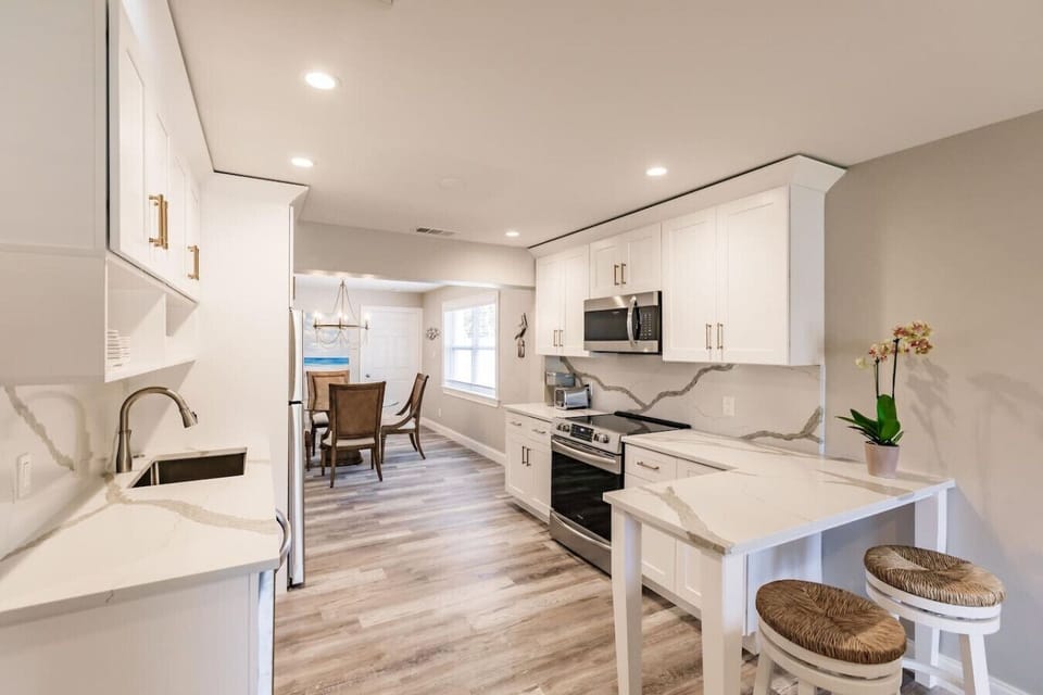 The kitchen is an open space looking onto the dining area and the living area with a couple of bar stools at the counter as well.