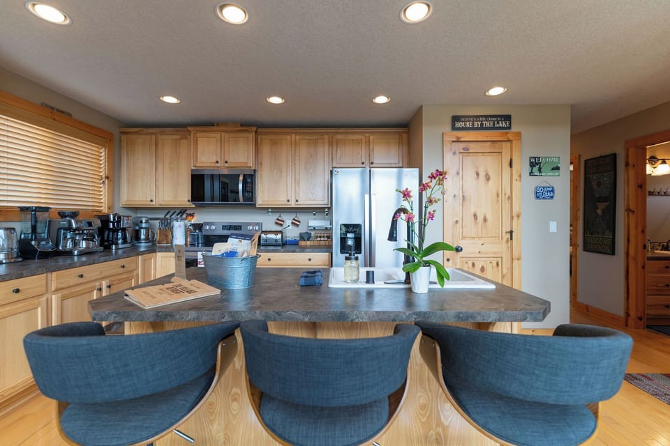 Open kitchen with island and bar dining