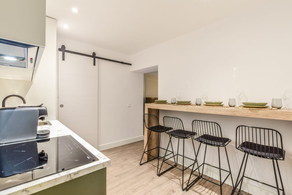Main view of the kitchen and dining space with high table and stools
