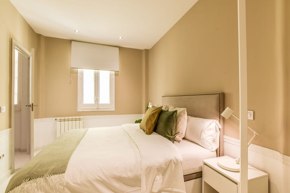 Main view of one of the bedrooms with a double bed and exterior windows