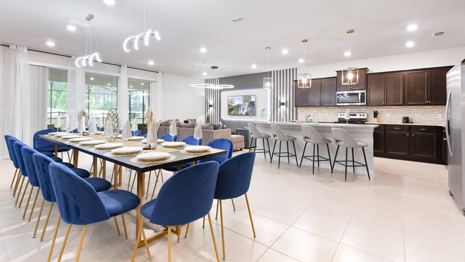 Elegant open-concept kitchen and dining area with seating for large groups.