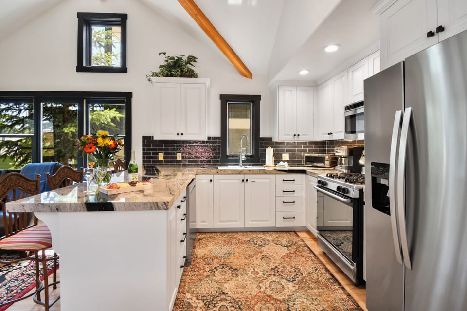 The fully equipped kitchen features stainless steel appliances, generous prep space, and everything needed for effortless home-cooked meals.