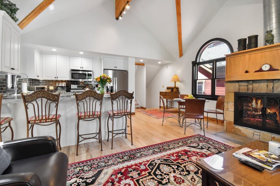 The bright open-concept main level seamlessly connects the kitchen, dining, and living areas, creating an inviting space for gathering and relaxation.