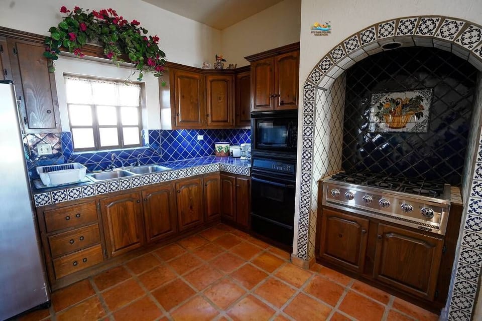 Cook with ease in the full kitchen of this Chaparral vacation rental at El Dorado Ranch San Felipe — stove, fridge, and counter space included.