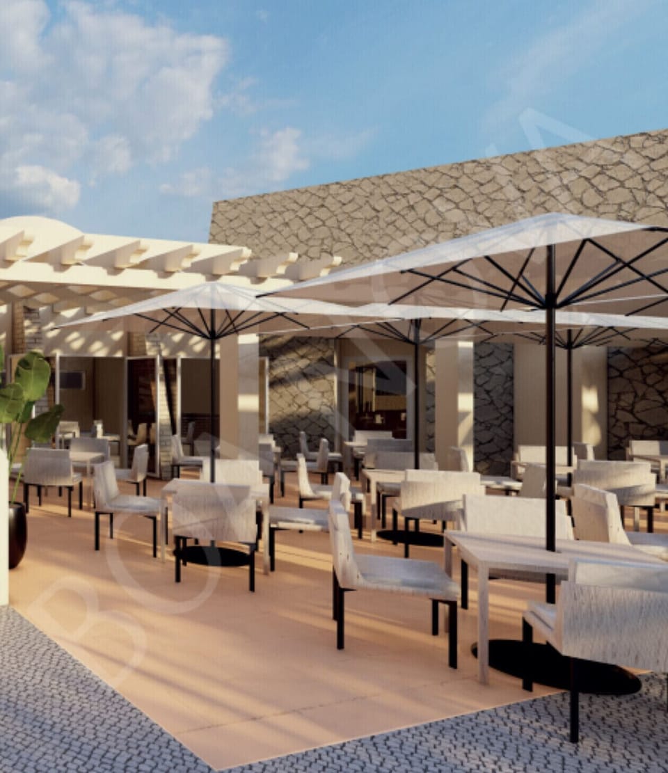 Aerial view of the swimming pool area with sun loungers and cabanas at Boa Nova resort, near Carvoeiro, Algarve