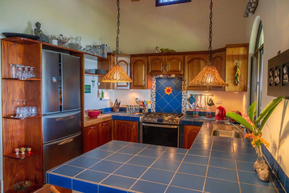 Fully set up kitchen with ocean views, large fridge with bottom freezer drawer.