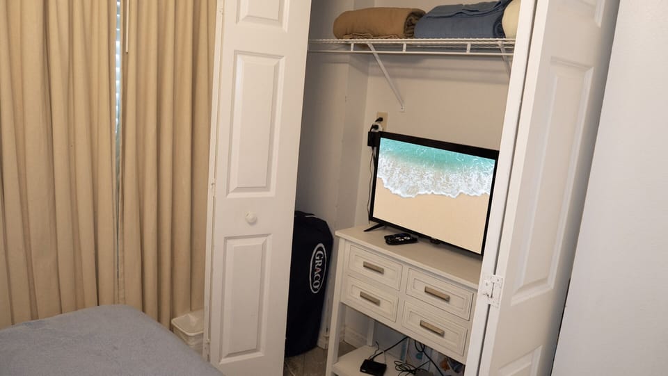 TV in the closet of the guest bedroom