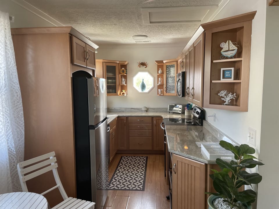 Kitchen with refrigerator, dishwasher, microwave, toaster oven and coffee maker