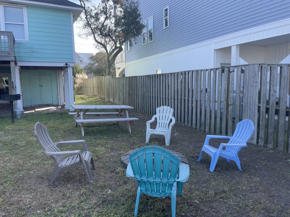 Gas BBQ grill. Fire pit with four chairs and picnic table