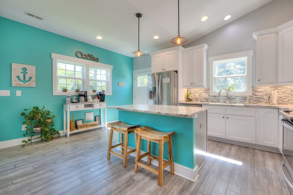 View of kitchen and hot drink station.  Back door opens to rear porch area.