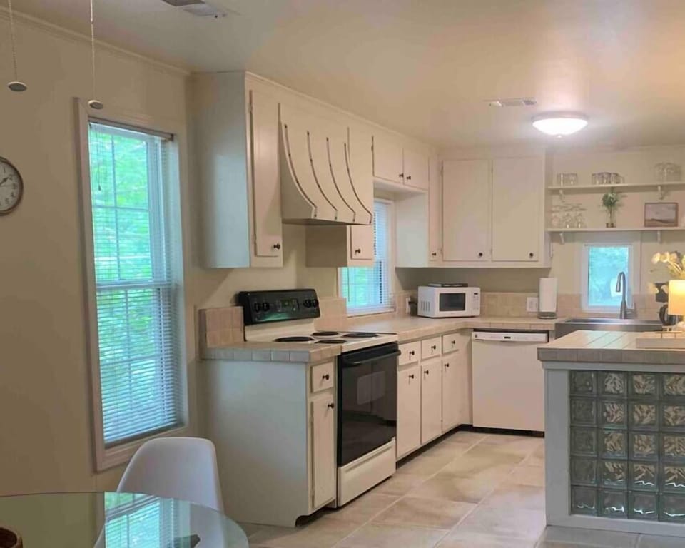 Fully equipped kitchen with forest views for peaceful meal prep.