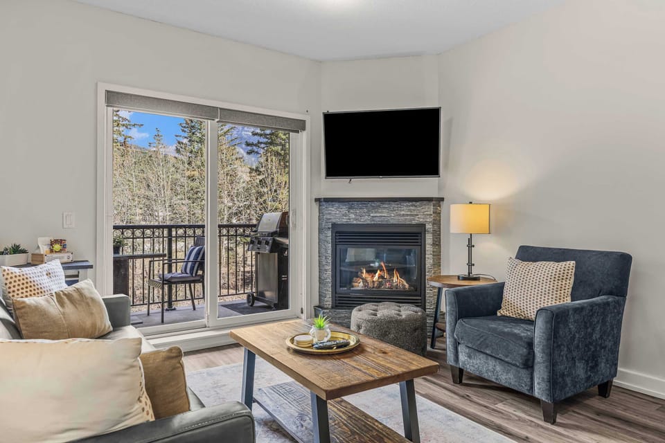 Living area with fireplace and balcony access