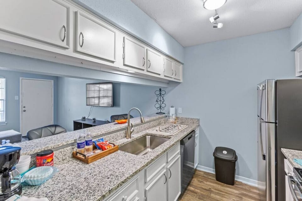 Updated kitchen area offering stainless appliances and sleek breakfast bar.