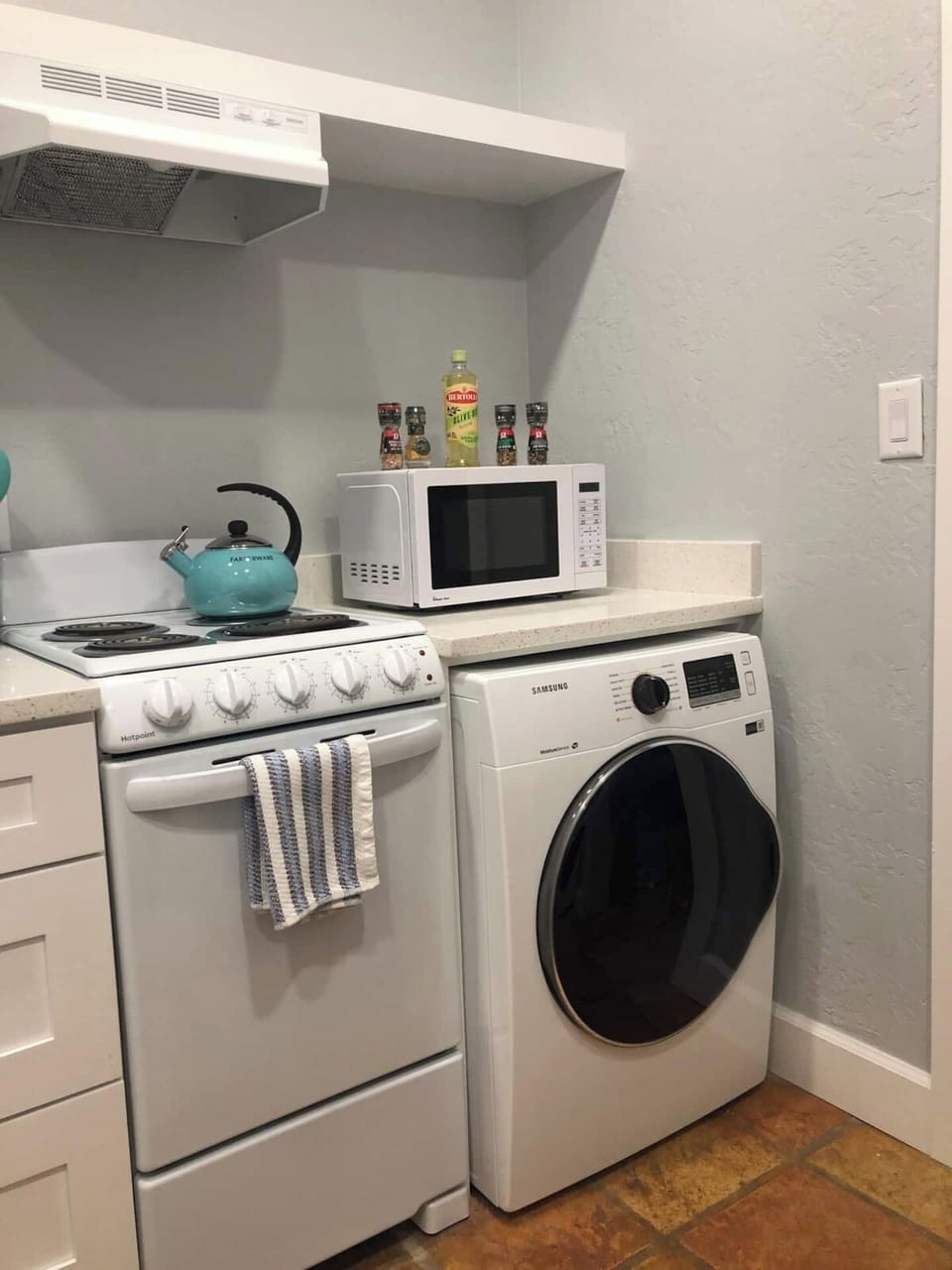 20" range, 24" Front-load clothes dryer, tea kettle, basic spices, microwave!