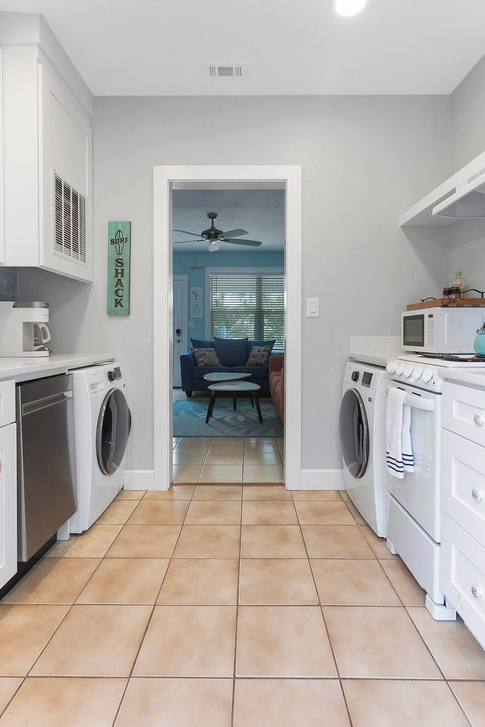 24" front load Samsung washer & Dryer, 18" stainless steel dishwasher, 20" four burner range, microwave, tea kettle, basic spices