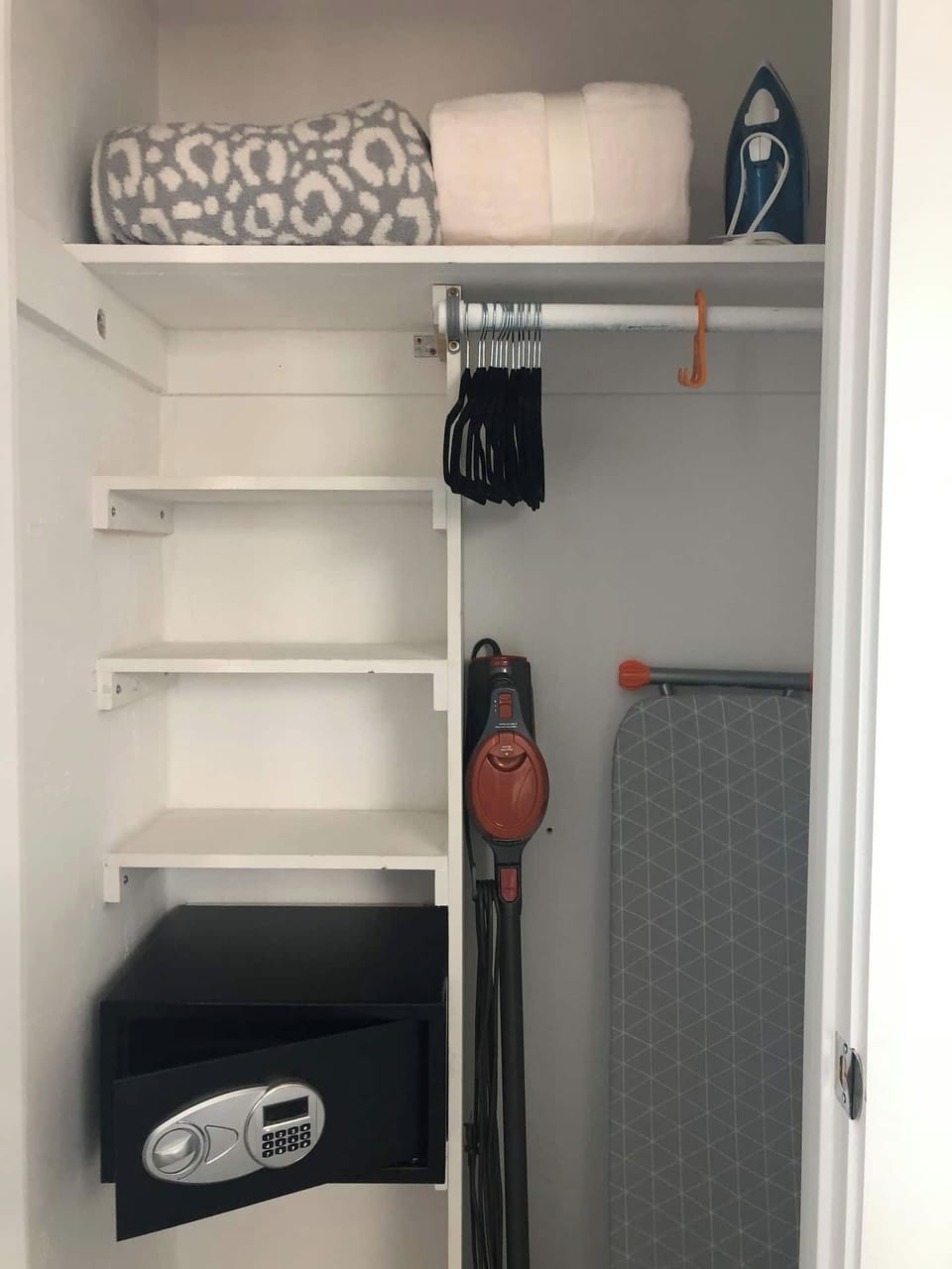 King Room Closet - safe for your valuables, Stick Vacuum, Iron and Ironing board, hangers, extra blanket.