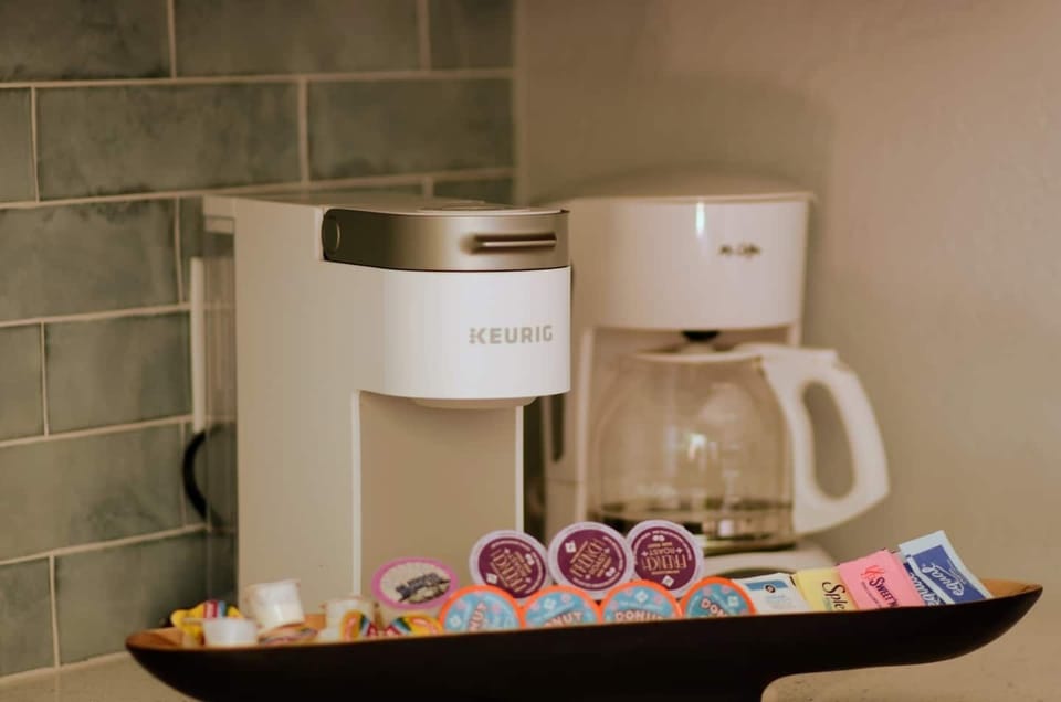 Coffee Station, Keurig coffee maker, Mr. Coffee drip coffee maker.  Keurig coffee pods, creamer, and a variety of sweeteners.