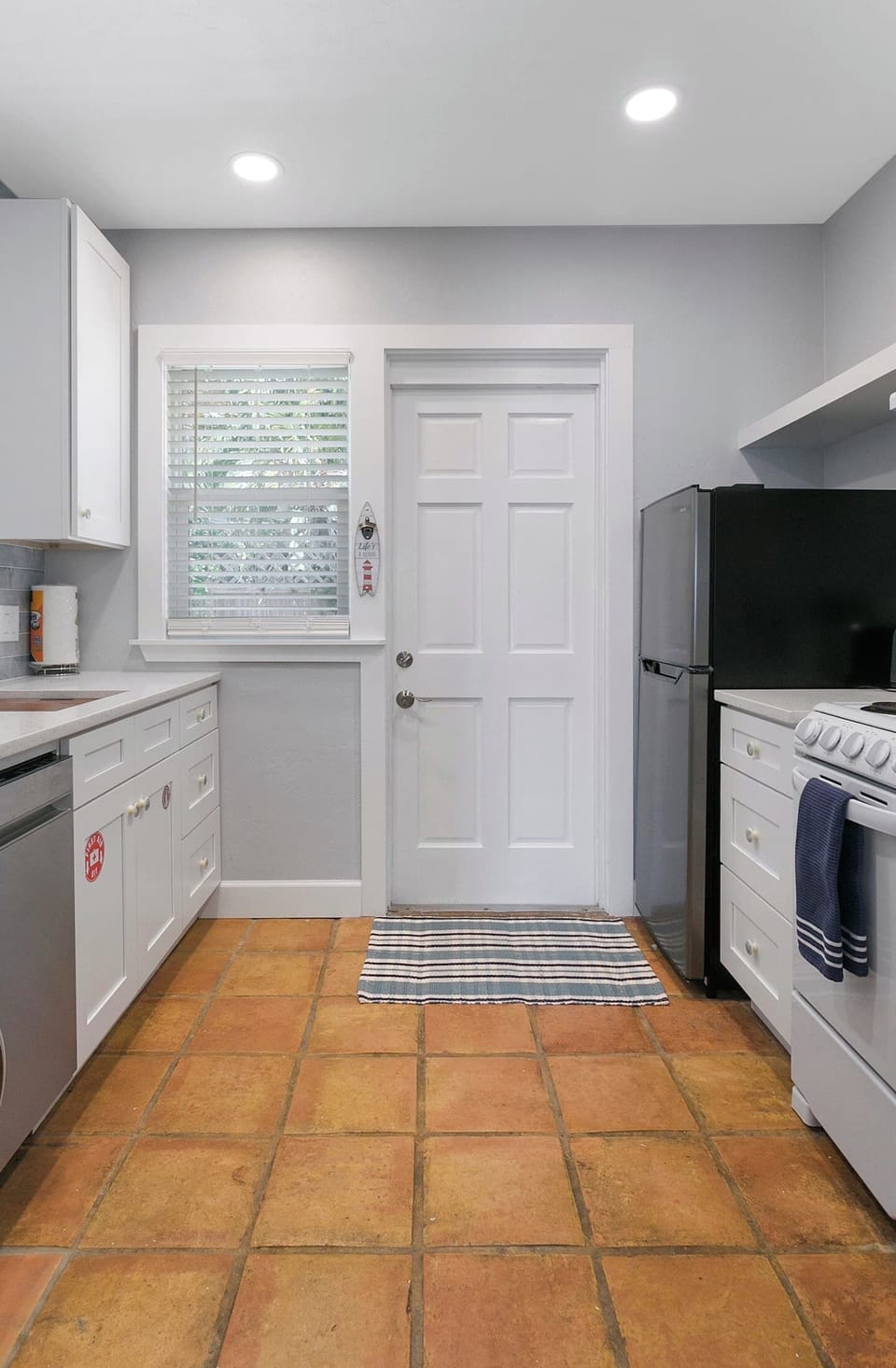 Brand New Kitchen with apartment-size appliances makes for extremely efficient use of a small space.  18" Stainless steel dish washer, 20" four burner range, 10 cu ft stainless refrigerator