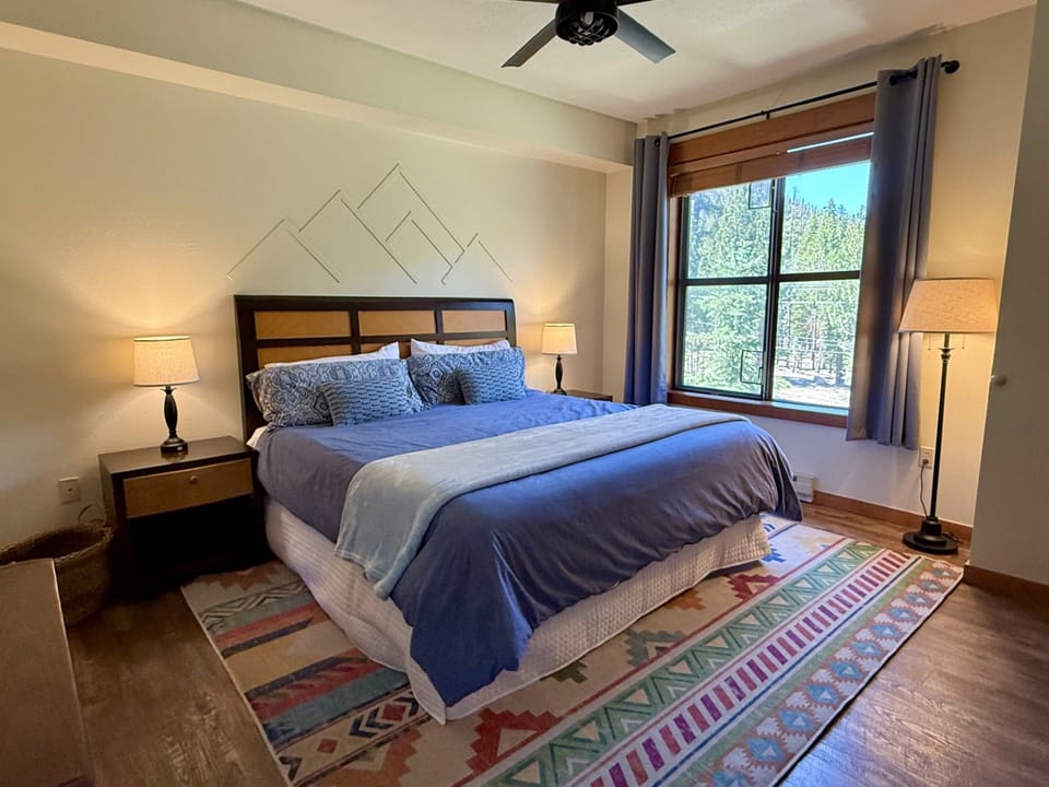 Master bedroom with king bed, TV, ceiling fan and on-suite bathroom,