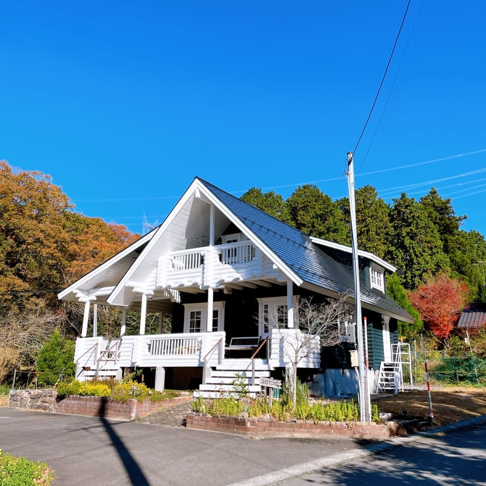 A white log house is a landmark.
