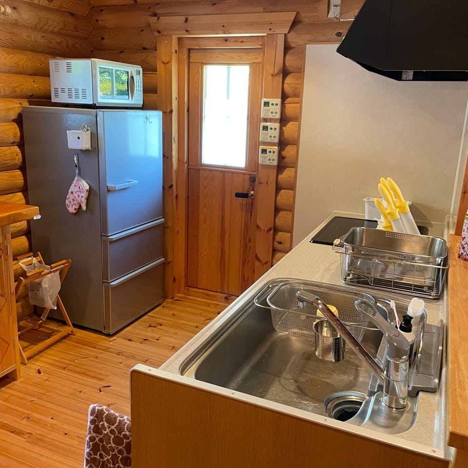The oven range is above the refrigerator.
