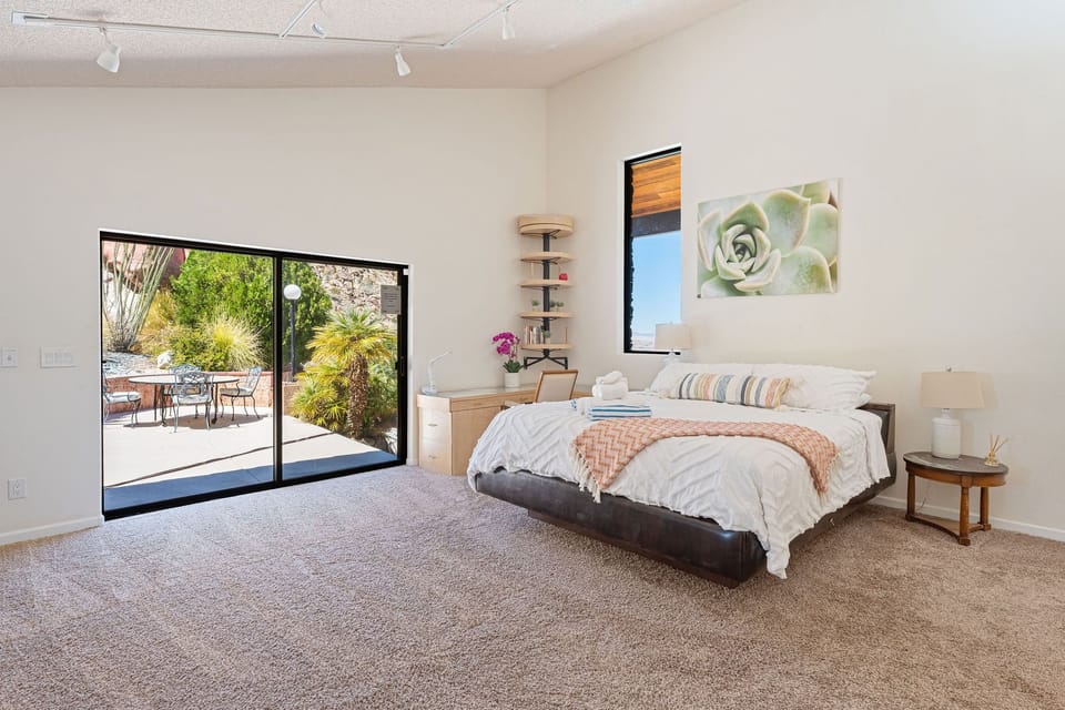 2nd bedroom with en-suite bathroom, flat screen tv, desk, slider to spa and pool