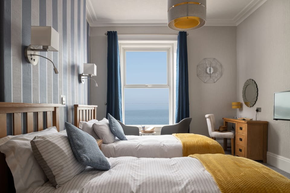 Deluxe Twin Room, Sea View | Hypo-allergenic bedding, desk, iron/ironing board, free WiFi