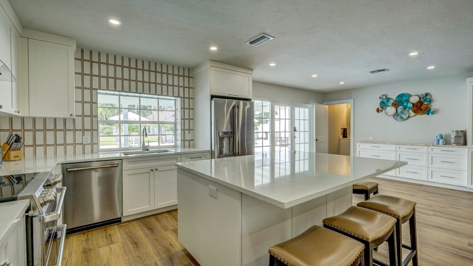 As seen in the picture, the kitchen comes stocked with a  dishwasher and fridge. It also offers a large island to eat at.